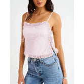 Model displaying a short lace trim satin cami top with an open back.